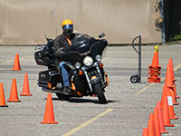 Photo of a motorcycle rider driving on a training course.