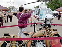 A helicopter and vintage motorcycle at the state patrol's booth at the Minnesota State Fair