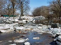 Floodwater and ice chunks on a road