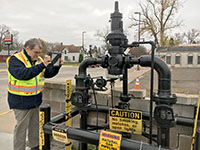 Photo of a Minnesota Office of Pipeline Safety inspector looking at a natural gas pipe.