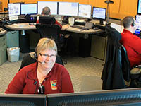 Three dispatchers working at computers
