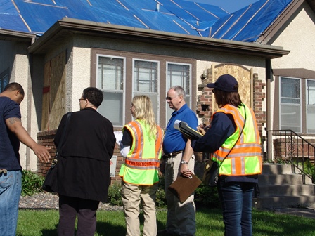 Emergency management staff assessing tornado damage in Minneapolis