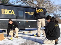 Three BCA agents document evidence on the ground
