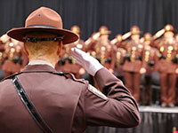 Photo of troopers saluting at graduation.