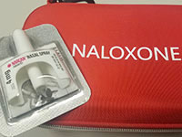 Narcan nasal spray bottle and carrying case.