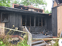 Photo of a home damaged in a fire caused by careless smoking.