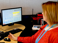 Photo of a dispatcher showing the technology that allows people to text 911 in an emergency.