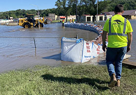 Workers build a sandbag wall to hold back floodwaters