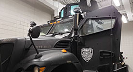 An armored vehicle with the City of New Hope Police Department's patch on the door