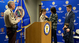 Lt. Col. Christina Bogojevic during her promotion ceremony with her family and Col. Matt Langer looking on.