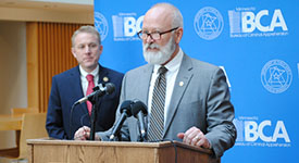 Department of Public Safety Commissioner Bob Jacobson speaks at a news conference as BCA Superintendent Drew Evans looks on.