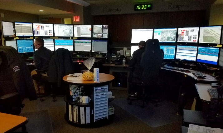 Two 911 dispatchers at their workstations