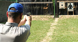 A man shooting a handgun at targets
