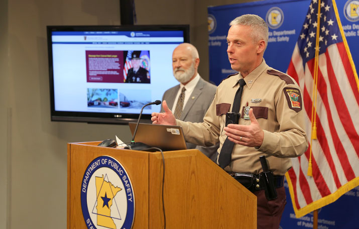 Col. Matt Langer speaks at a news conference as DPS Commissioner Bob Jacobson looks on.