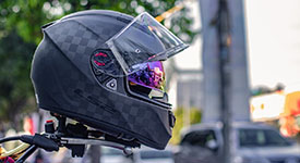 A helmet sitting on the handlebars of a motorcycle