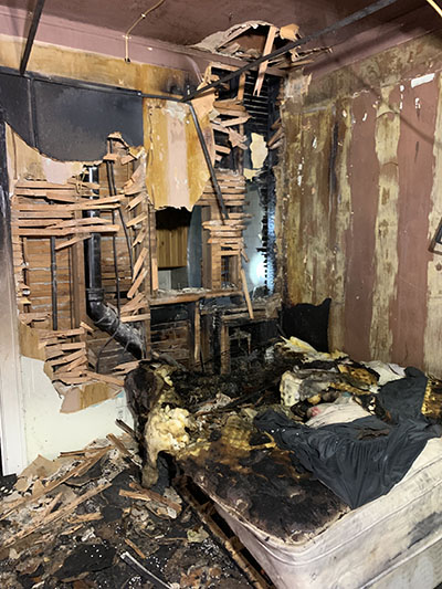 An appartment bedroom destroyed by fire.