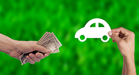 Image of a person handing over money for a paper car