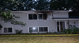 A charred house is shown following a fatal fire