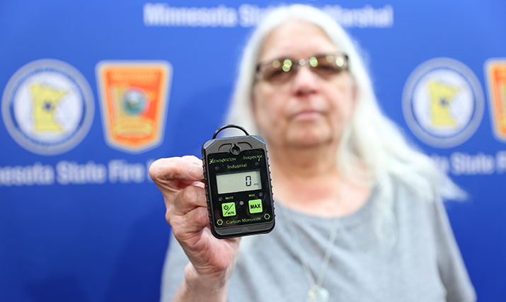 Denice Johnson holds a portable carbon monoxide alarm
