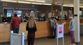 Staff and customers at a driver and vehicle services office