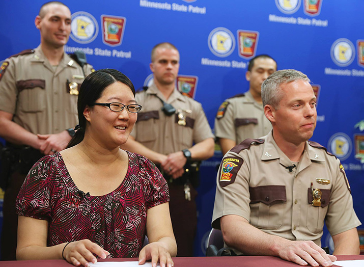 Lisa Jaeger and Col. Matt Langer with three state troopers standing behind them.