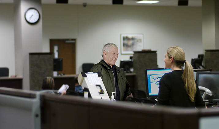 Photo of a man speaking with a Driver and Vehicle Services representative.