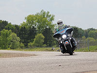 A motorcyclsit taking a curve on a road