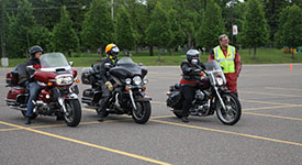 Members of the Motorcycle Safety Advisory Task Force watch their classmates during a MN Advanced Rider Course