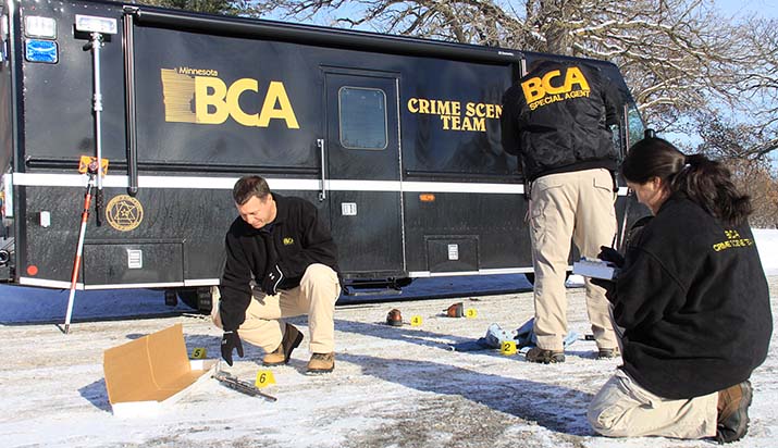 Three BCA agents document evidence on the ground