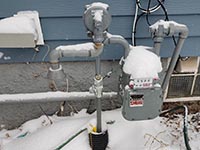 A gas meter with snow on it