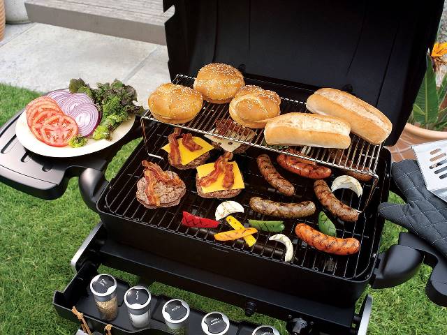 grill with food in backyard of home
