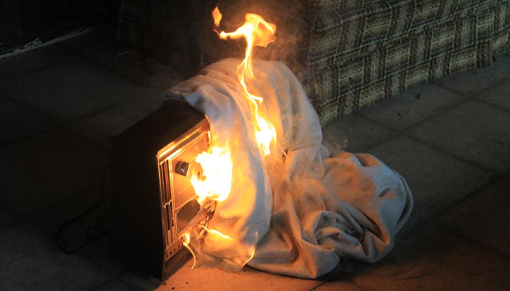 A blanket catching fire after it was thrown over a space heater
