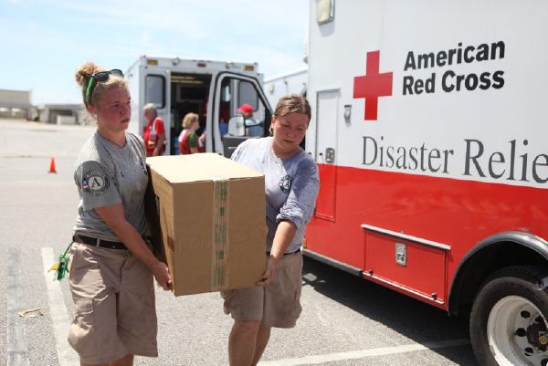 Red Cross workers carrying box of supplies