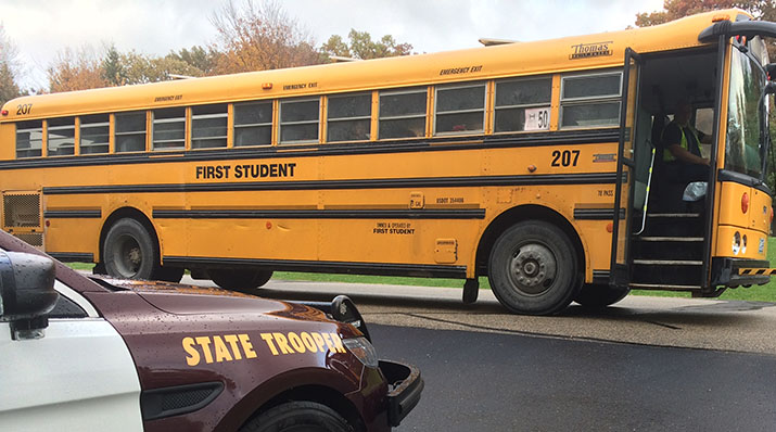 Photo of a school bus and a State Patrol squad car.