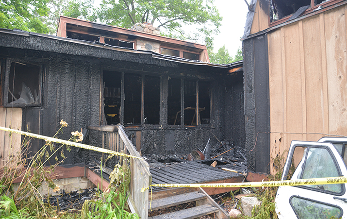 Photo of a home damaged by a fire caused by careless smoking.