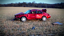 The car Logan Maas was riding in sits in a field after the crash