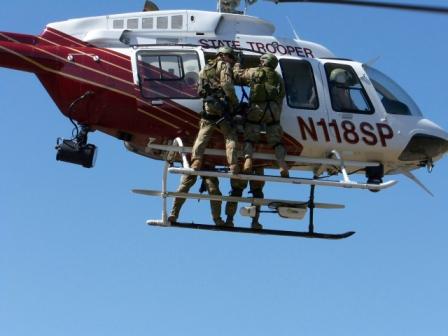 SRT troopers riding on helicopter skids