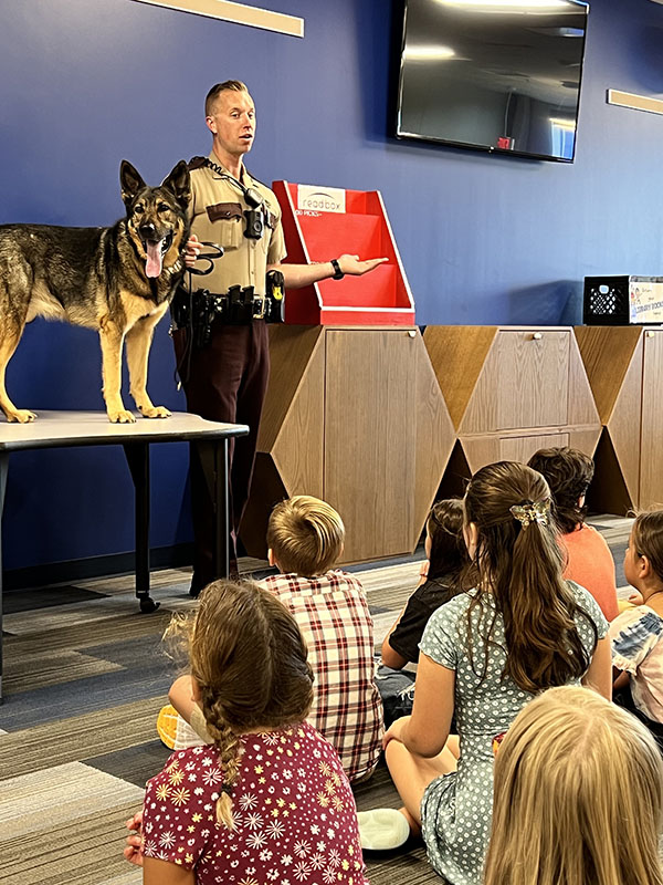 A State Patrol K-9 and its handler during a presentation to children.