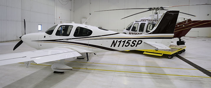 An MSP plane and helicopter parked in a hangar.