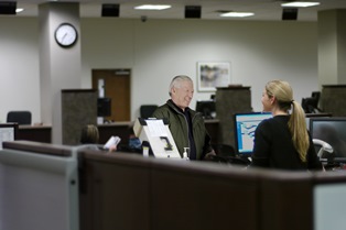 Photo of a resident at a license renewal office.