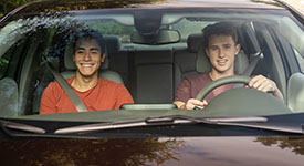 Two teenage boys demonstrate safe driving