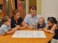 Photo of a family creating a fire escape plan.