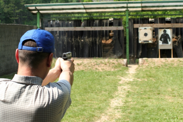Photo of a guy shooting a gun.