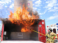 Flames shooting out of a cooking fire demonstration trailer