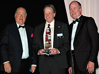 Jon Nisja accepts the James M. Shannon Advocacy Medal from NFPA President and CEO Jim Pauley and NFPA Board Chair Keith Williams