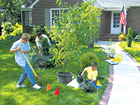 Photo of a family planting flowers and trees.