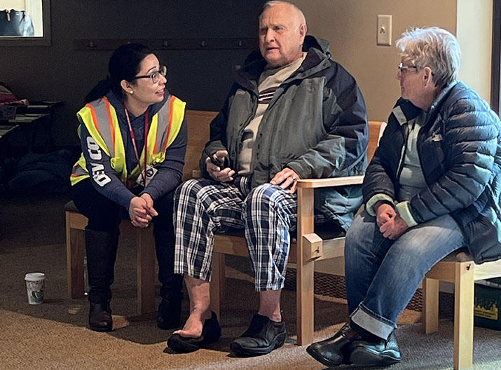 A member of the Willmar Area Community Emergency Response Team speaks with two people who were evacuated due to the Raymond train derailment.