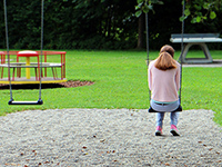 Photo of young girl on a swing