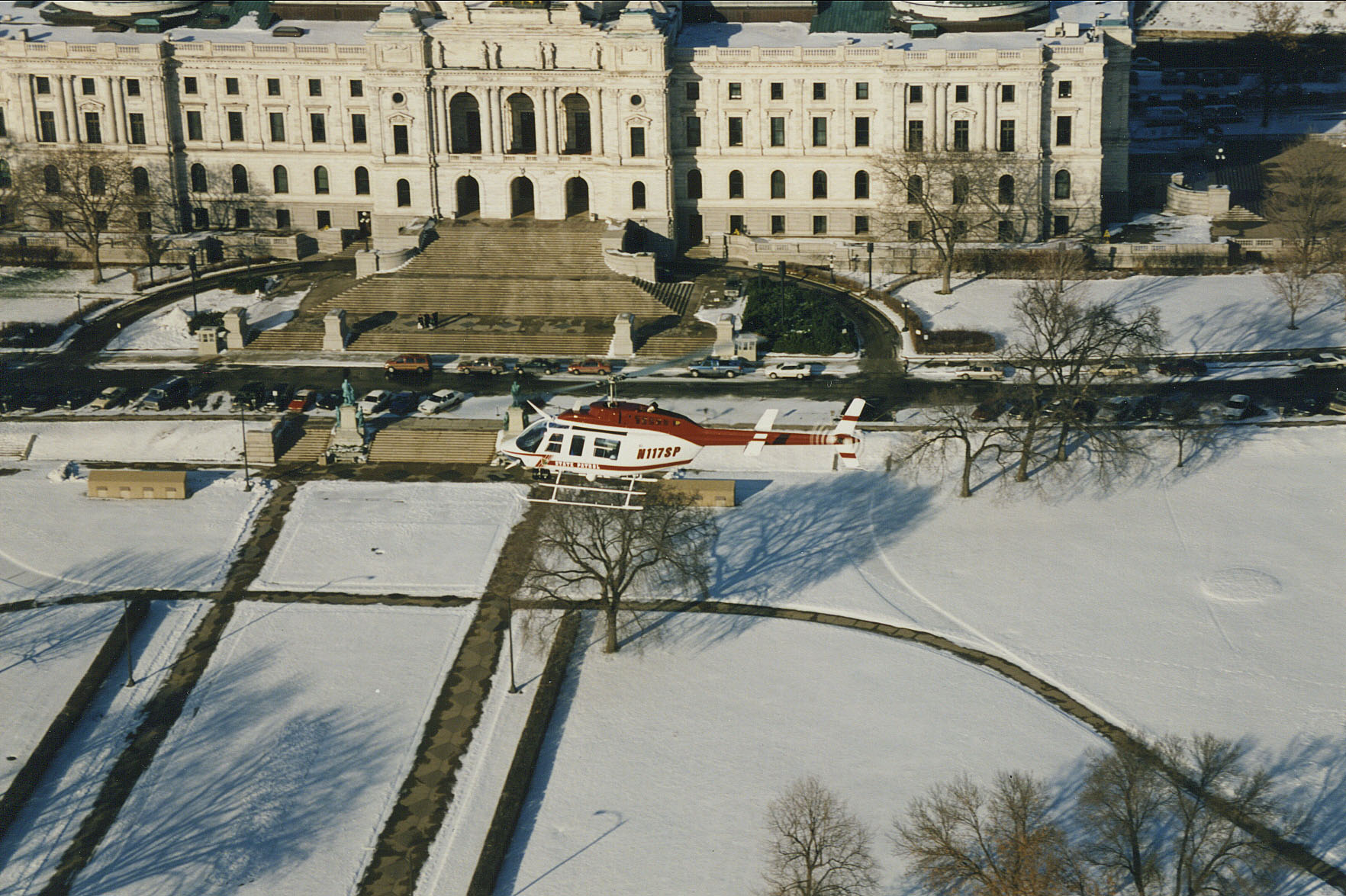 An early state patrol helicopter flying near the Minnesota Capitol building