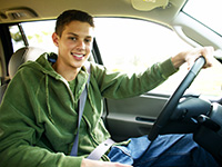 A teen behind the wheel of a car